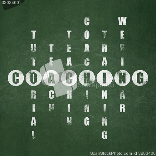 Image of Education concept: word Coaching in solving Crossword Puzzle