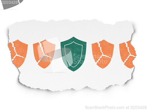 Image of Security concept: shield icon on Torn Paper background