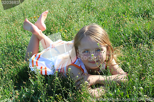 Image of little girl lying on the grass