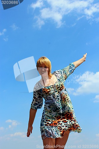 Image of blue-eyed sympathetic girl and blue sky