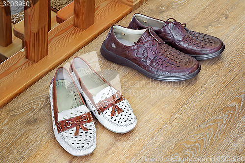 Image of Two pairs of comfortable shoes : for men and for women.