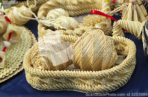 Image of Original Souvenirs of woven straw are sold at the fair.