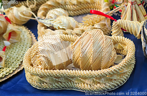 Image of Original Souvenirs of woven straw are sold at the fair.