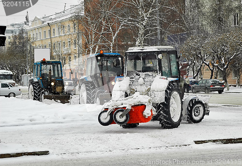 Image of Tractors with snowplowing equipment on streets