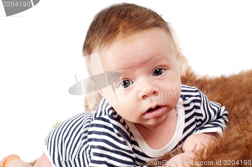 Image of Portrait of adorable baby boy lying on fur