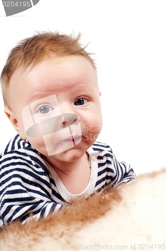 Image of Portrait of cute child lying on fur