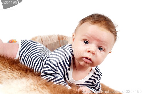 Image of Portrait of adorable baby boy lying on fur