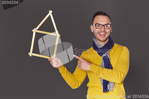 Image of Man showing house frame concept