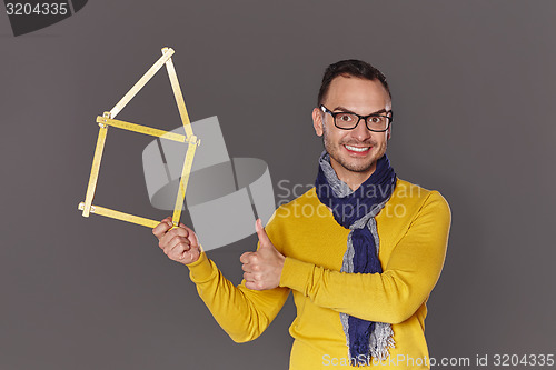 Image of Man showing house frame concept