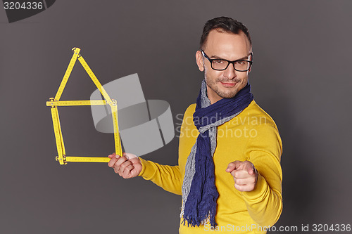 Image of Man showing house frame concept