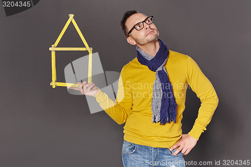 Image of Man showing house frame concept