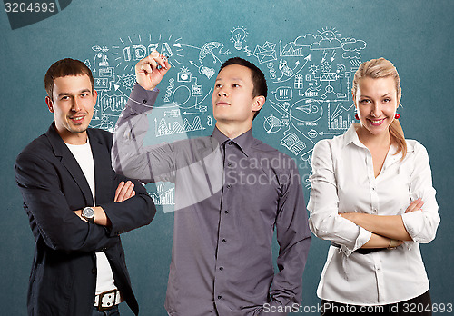 Image of Teamwork and Asian Man Writing Something