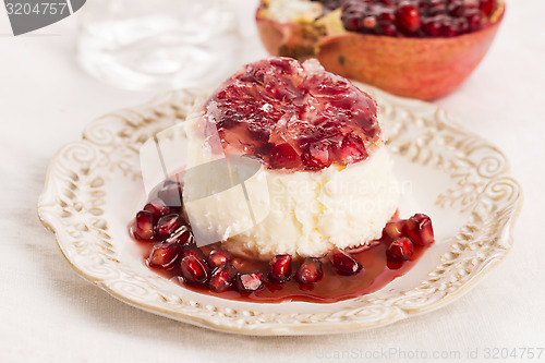 Image of coconut panna cotta dessert with pomegranate