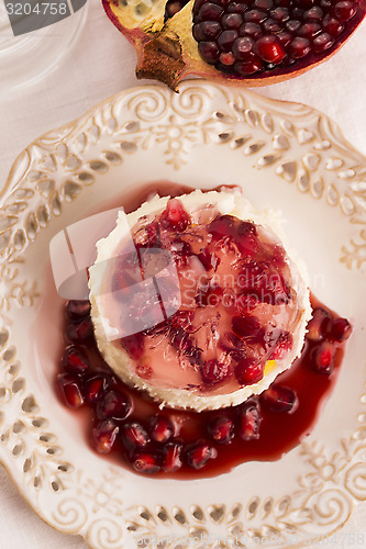 Image of coconut panna cotta dessert with pomegranate