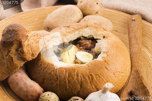 Image of traditional white borscht (zurek) with sausage,egg and mushrooms