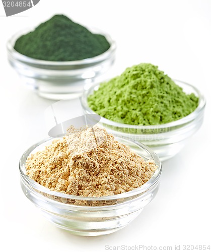 Image of three bowls of various superfood powders