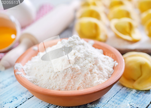 Image of flour and raw pelmeni