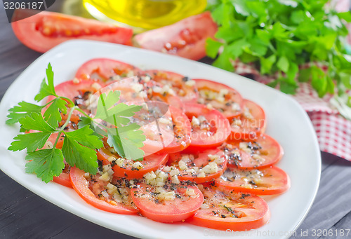 Image of tomato with basil and garlic