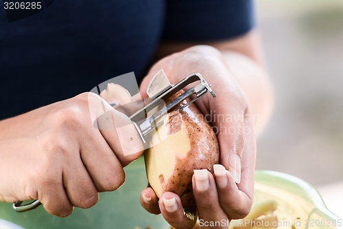 Image of Potato is peeled with a kitchen knife