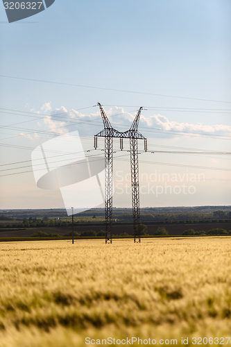 Image of Large transmission tower with field