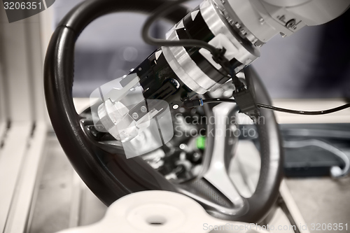 Image of Robotic arm tearing down steering wheel