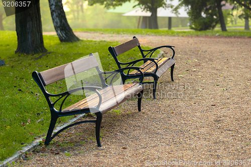 Image of Stylish bench in autumn park