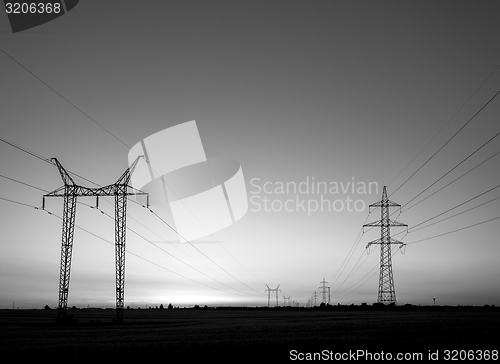 Image of Large transmission towers at sunset