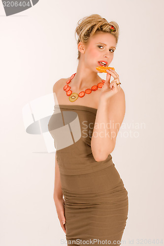 Image of Attractive blonde young woman with strawberry-kiwi   