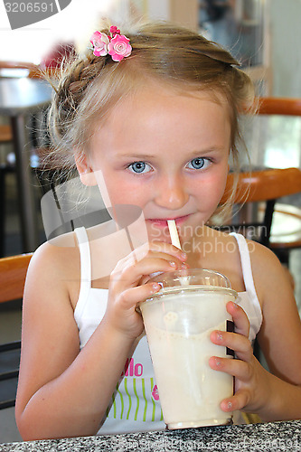 Image of little girl drinking the cocktail in fastfood