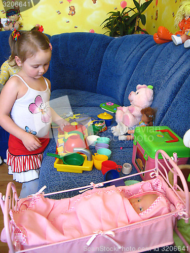 Image of girl playing with toys in her room