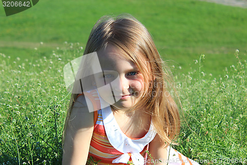 Image of portrait of little girl lying on the grass