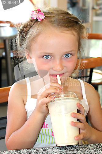 Image of beautiful girl drinking the cocktail in fastfood