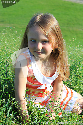 Image of portrait of little girl lying on the grass