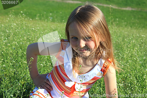 Image of portrait of little girl lying on the grass