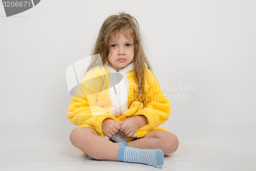 Image of Offended girl in yellow bathrobe