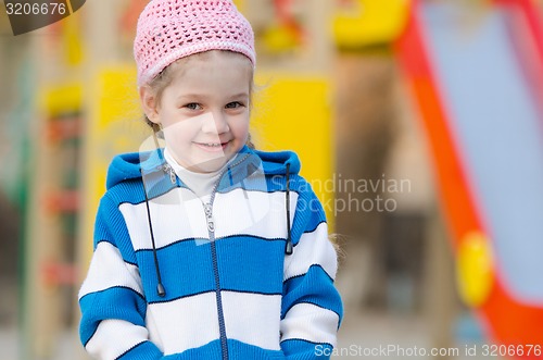 Image of Portrait of cheerful four-year girl in playground