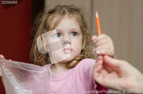 Image of Girl takes from the hands of moms pencil