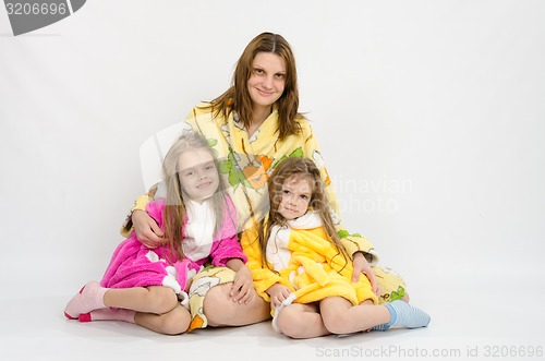 Image of Mom with two daughters in bath robes