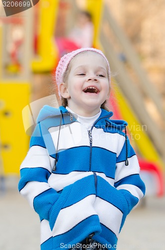 Image of Four-year girl laughing in the playground