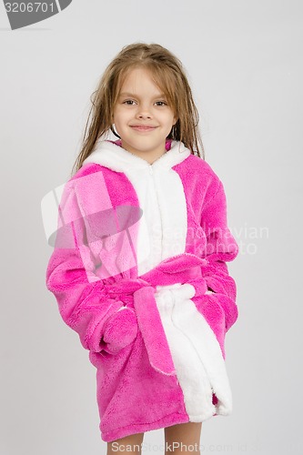 Image of Portrait of six-year girl in a pink bathrobe