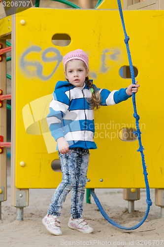Image of Worried little girl playing on the playground