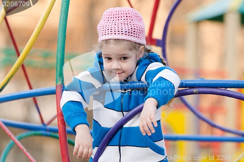 Image of Four-year girl provocatively wondered at the playground