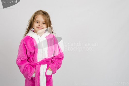 Image of Six year old girl in bathrobe, a place under an inscription