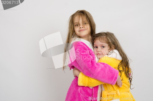 Image of Girls in gowns hug after swimming