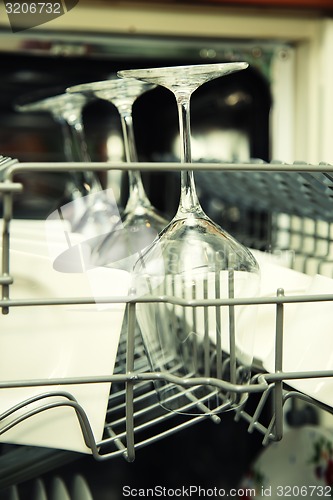 Image of details of Open dishwasher with clean utensils