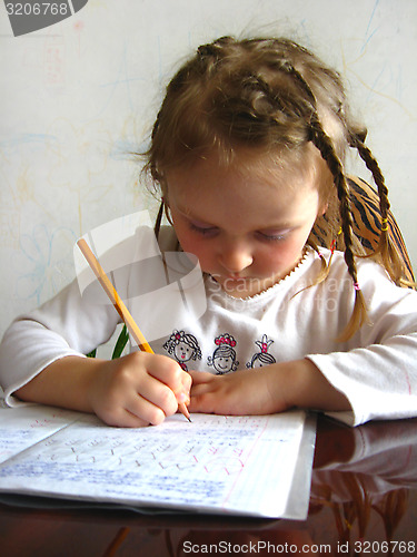 Image of girl learning her home tasks