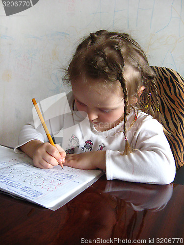 Image of girl learning her home tasks
