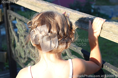 Image of little fashionable girl with beautiful coiffure