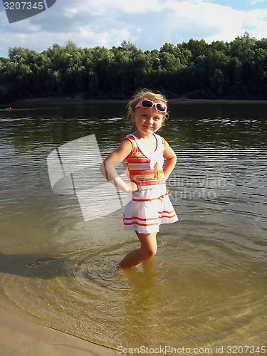 Image of little girl standing in the river