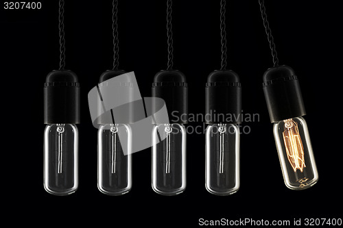 Image of Lightbulbs swinging pendulum